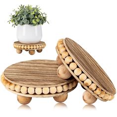 two wooden stools and a potted plant sit on top of each other in front of a white background