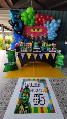 the table is decorated with legos and balloons