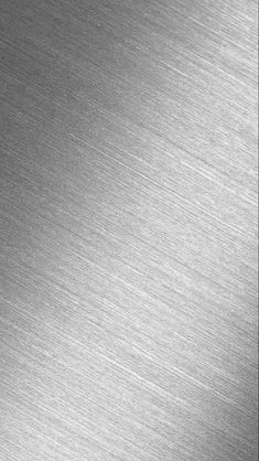 a close up view of a shiny metal surface that looks like it has been brushed