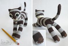 a stuffed animal cat is posed next to a pencil