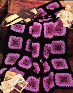 there is a crocheted blanket on top of a bed with an old book