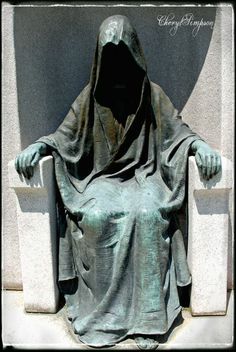 a statue of a person with a hood on