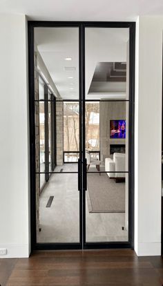 an open glass door leading into a living room