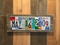 a license plate hanging on the side of a wooden fence