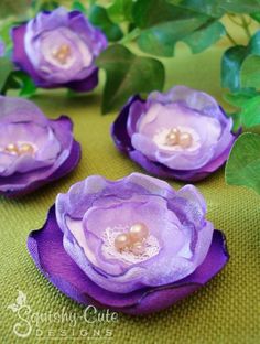 purple flowers with leaves and pearls on them