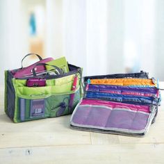 two purses sitting next to each other on a table