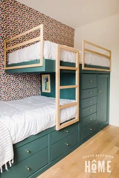 a bunk bed in a room with green drawers