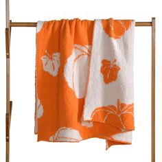 an orange and white towel hanging on a clothes rack