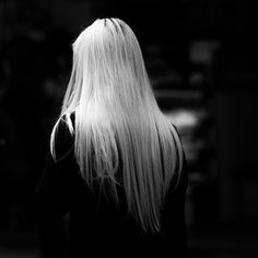 the back of a woman's head with long white hair