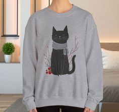 Minimalist Cat Sweatshirt, Cute Black Cat Shirt, Dapper Dressed Country Cat Lover Gift, Cat Mom Sweater Gift, Holiday Hoodie, Teacher Gift - A charming blend of feline coziness and quirky style with our latest sweatshirt featuring a whimsical graphic of a cat that exudes unparalleled charm. Picture this: a dapper cat standing upright, sporting an endearing ensemble of mismatched patterns--think a cozy sweater, a delightful scarf. This playful design is a delightful fusion of comfort and whimsy, making it the purr-fect addition to your wardrobe for those cozy days that call for a touch of feline-inspired charm and warmth. 👉🎨About the Designer: At FlooredByArt Studios, I blend a passion for nature and animals with over 30 years of artistic expertise. Each design, crafted with cutting-edge Cat Mom Sweater, Cat Standing, Quirky Style, Holiday Hoodies, Cute Black Cat, Mom Sweater, Cute Black Cats, Sweatshirt Cute, Cat Sweatshirt