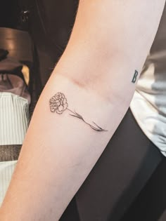 a person with a flower tattoo on their arm