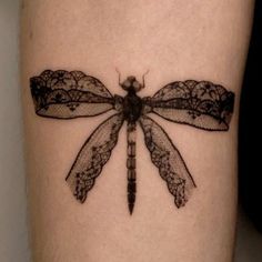 a black and white photo of a dragonfly tattoo