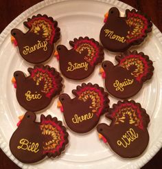 decorated cookies are arranged on a plate with name tags in the shape of turkeys