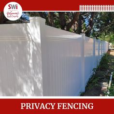 the privacy fence is white and has red lettering that says privacy enclosing it