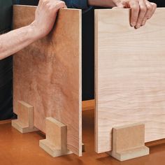 two people are working on woodworking with one person holding the other's hand