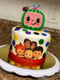 a birthday cake decorated with cartoon characters on it