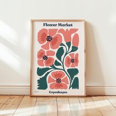 a flower market poster on the wall in an empty room with wood flooring and white walls