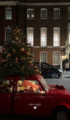 a small red car with a christmas tree on top