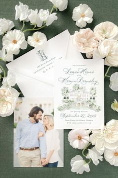 the wedding stationery is surrounded by white flowers