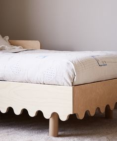 the bed is made up and ready for someone to use it in their home or office