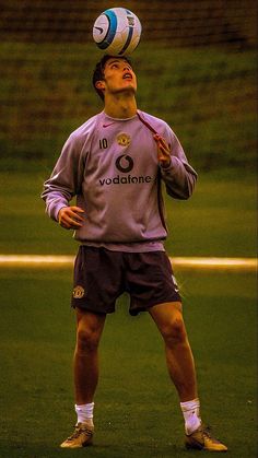 a soccer player in the air with a ball on his head