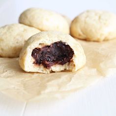 several pastries sitting on top of a piece of wax paper