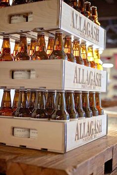 several boxes stacked on top of each other with beer bottles in the bottom one is labeled allagash