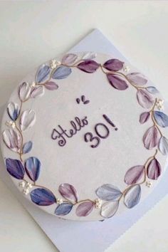 a birthday cake decorated with purple leaves and the number forty five on it's side