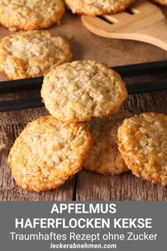 some oatmeal cookies stacked on top of each other in front of a wooden spoon