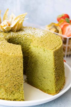 a green cake is on a white plate