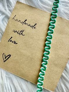 a handmade with love note attached to a string