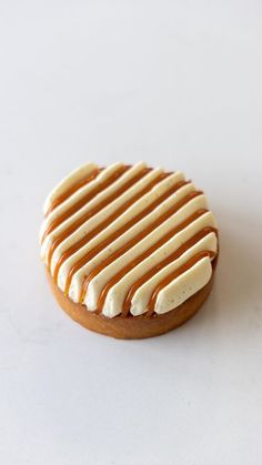 a cookie with icing on it sitting on a table