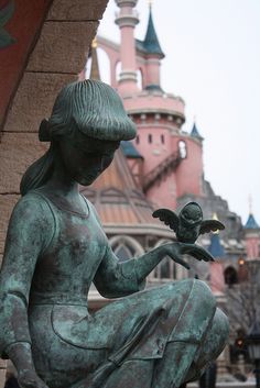 there is a statue that has a bird in it's hand