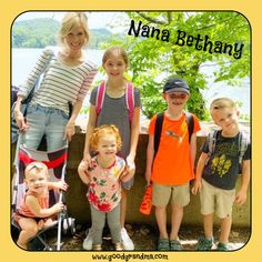 a group of children standing next to each other in front of a body of water