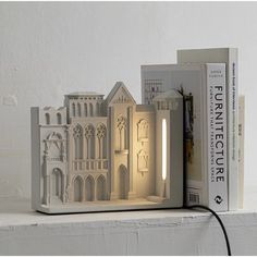 a lamp that is sitting on top of a book shelf next to a bookshelf