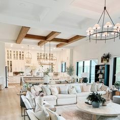 a living room filled with furniture and a chandelier