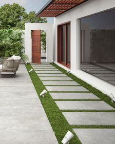 an outdoor patio with grass and steppings leading to the front door is seen in this artist's rendering