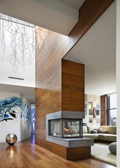 a modern living room with wood floors and white walls