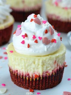 cupcakes with white frosting and pink sprinkles