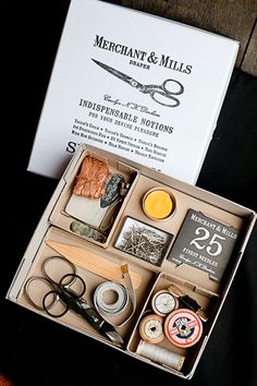 an open box containing scissors and other items