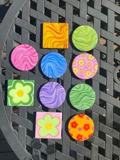 some colorful coasters sitting on top of a metal table