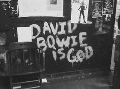 a black and white photo of a wall with writing on it that says david brown is god