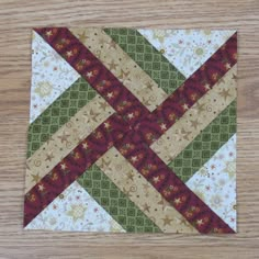 a close up of a piece of fabric on a wooden table with wood flooring