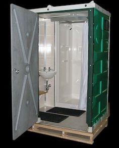 a white toilet sitting inside of a metal enclosure