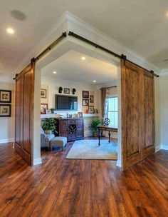 an open living room with sliding barn doors