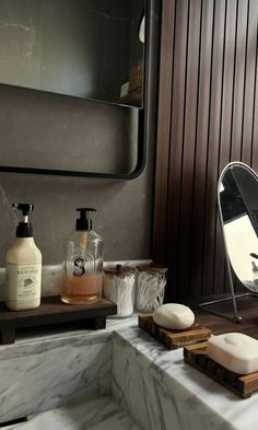 a bathroom with marble counter tops and wood paneling