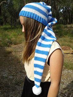 a woman wearing a blue and white striped hat