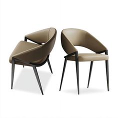 two modern chairs sitting next to each other