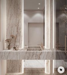 an elegant bathroom with marble walls and floors