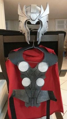 an iron man cape and mask sitting on top of a chair